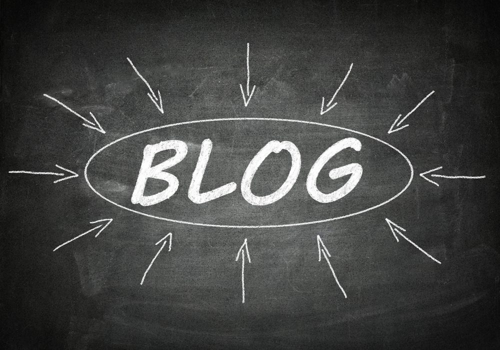 Chalkboard displaying the word BLOG at its center, surrounded by arrows pointing inward. The dark background enhances the white chalks simplicity—almost like transforming podcast episodes into blog posts, channeling content into a new form.