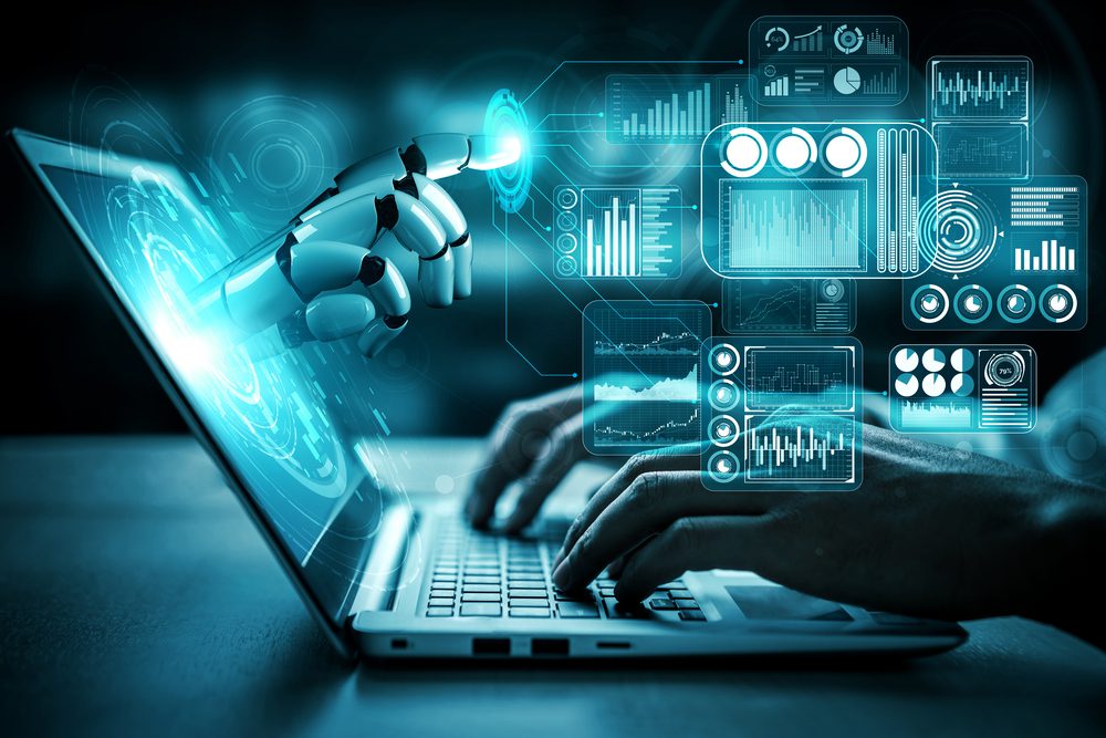 A robotic hand reaches out toward a glowing interface with futuristic data graphics, symbolizing AI in marketing. In the foreground, human hands are typing on a laptop keyboard, seamlessly merging human interaction with technology.